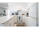 Well-equipped galley-style kitchen with white cabinets and appliances at 3509 S Atlantic Ave # 209, New Smyrna Beach, FL 32169