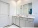 Double vanity bathroom with modern white cabinets and quartz countertops at 3975 Willowbrook Dr, Edgewater, FL 32141