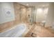 Elegant bathroom with soaking tub, walk-in shower, and marble floors at 241 Riverside Dr # 510, Holly Hill, FL 32117