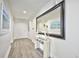Bright and spacious entryway with wood-look flooring and large mirror at 241 Riverside Dr # 510, Holly Hill, FL 32117