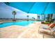 Relaxing pool area with blue umbrellas and lounge chairs at 241 Riverside Dr # 510, Holly Hill, FL 32117