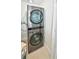 Modern laundry room with stacked washer and dryer at 241 Riverside Dr # 510, Holly Hill, FL 32117