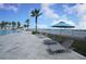 Poolside lounge chairs and umbrellas overlooking water at 241 Riverside Dr # 510, Holly Hill, FL 32117
