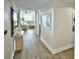 Light and airy hallway with wood-look flooring, leading to living areas at 241 Riverside Dr # 510, Holly Hill, FL 32117