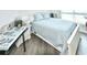 Bright bedroom with a comfortable bed and wood-look flooring at 241 Riverside Dr # 510, Holly Hill, FL 32117