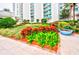 Lush landscaping, featuring a variety of plants and flowers, enhances this condo's courtyard at 241 Riverside Dr # 510, Holly Hill, FL 32117