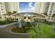 Elegant building entrance with a covered driveway and lush landscaping at 241 Riverside Dr # 510, Holly Hill, FL 32117