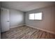 Bright bedroom with wood-look flooring and a large window at 101 N Riverside Dr # 4140, New Smyrna Beach, FL 32168