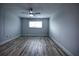 Bright bedroom with ceiling fan and wood-look flooring at 101 N Riverside Dr # 4140, New Smyrna Beach, FL 32168