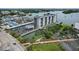 Aerial view of waterfront property, showing the building, parking lot, and marina at 101 N Riverside Dr # 4140, New Smyrna Beach, FL 32168