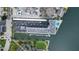 Aerial view of building with parking, pool, and boat docks at 101 N Riverside Dr # 4140, New Smyrna Beach, FL 32168