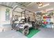 Garage with golf cart, bicycle, and storage shelving at 306 Coral Reef Way, Daytona Beach, FL 32124