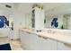 Clean bathroom with double vanity, white cabinets, and a large mirror at 241 Riverside Dr # 2007, Holly Hill, FL 32117