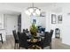 Elegant dining room with a round black marble table and six black leather chairs at 241 Riverside Dr # 2007, Holly Hill, FL 32117