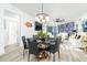 Elegant dining room with a round black marble table and six black leather chairs at 241 Riverside Dr # 2007, Holly Hill, FL 32117