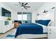 Relaxing main bedroom with a king-size bed, dresser, and large window at 241 Riverside Dr # 2007, Holly Hill, FL 32117
