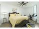 Bright bedroom with a yellow comforter, gray upholstered bed frame, and a workspace at 241 Riverside Dr # 2007, Holly Hill, FL 32117