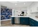Modern kitchen with island, teal cabinets, quartz countertops, and stainless steel appliances at 241 Riverside Dr # 2007, Holly Hill, FL 32117