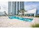 Relaxing pool area with lounge chairs and a modern building in the background at 241 Riverside Dr # 2007, Holly Hill, FL 32117