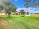 Landscaped backyard with pond view and access to a canal at 1805 Turnbull Lakes Dr, New Smyrna Beach, FL 32168