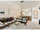 Bright living room with comfy sofas, a glass coffee table, and view into kitchen at 1805 Turnbull Lakes Dr, New Smyrna Beach, FL 32168