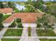 An aerial shot showcasing a charming villa-style home with a double garage at 1805 Turnbull Lakes Dr, New Smyrna Beach, FL 32168