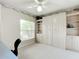 Bedroom with built-in wall bed, shelving, and a desk at 1805 Turnbull Lakes Dr, New Smyrna Beach, FL 32168