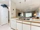 Kitchen with light wood cabinets, double sink, and a view to the living room at 1805 Turnbull Lakes Dr, New Smyrna Beach, FL 32168