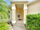 Inviting front entry with a covered porch and well-manicured landscaping at 1805 Turnbull Lakes Dr, New Smyrna Beach, FL 32168