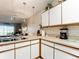 White kitchen cabinets, a built-in microwave and an electric range at 1805 Turnbull Lakes Dr, New Smyrna Beach, FL 32168