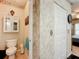 Small bathroom with toilet and bamboo-themed wallpaper at 1805 Turnbull Lakes Dr, New Smyrna Beach, FL 32168