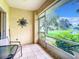 Screened porch with table and chairs overlooking a tranquil lake at 1805 Turnbull Lakes Dr, New Smyrna Beach, FL 32168
