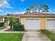 Front exterior of the house with a double-car garage at 1805 Turnbull Lakes Dr, New Smyrna Beach, FL 32168