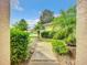 Landscaped walkway leading through lush greenery to a neighboring home at 1805 Turnbull Lakes Dr, New Smyrna Beach, FL 32168