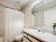 Bathroom with shower, sink, toilet, and seashell-themed wallpaper at 1805 Turnbull Lakes Dr, New Smyrna Beach, FL 32168