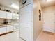 A galley-style kitchen with white cabinets, and a breakfast bar at 1805 Turnbull Lakes Dr, New Smyrna Beach, FL 32168