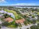 Aerial view of a beautiful home community near a golf course and lake at 1805 Turnbull Lakes Dr, New Smyrna Beach, FL 32168
