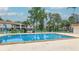 Community pool with lounge chairs and umbrellas at 1600 Big Tree Rd # D2, South Daytona, FL 32119