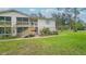 Condo building entrance with stairs and landscaping at 1600 Big Tree Rd # D2, South Daytona, FL 32119