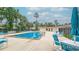Community pool area with surrounding lounge chairs at 1600 Big Tree Rd # D2, South Daytona, FL 32119