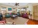 Bright living room with bay window, hardwood floors, and ceiling fan at 1206 S Riverside Dr, New Smyrna Beach, FL 32168