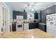 Updated kitchen with dark cabinetry, granite counters, and white appliances at 1206 S Riverside Dr, New Smyrna Beach, FL 32168
