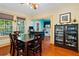 Bright dining room with hardwood floors and view into kitchen at 1206 S Riverside Dr, New Smyrna Beach, FL 32168