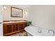 Bathroom with a double vanity and clawfoot tub at 1206 S Riverside Dr, New Smyrna Beach, FL 32168
