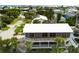 An aerial view showcasing a two-story home with a large deck and a white roof at 824 Eel Ave, New Smyrna Beach, FL 32169