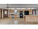 Kitchen with wood cabinets, black appliances, and an island at 824 Eel Ave, New Smyrna Beach, FL 32169