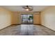 Bright living room with tile floors and sliding glass doors leading to a balcony with water views at 824 Eel Ave, New Smyrna Beach, FL 32169