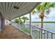 Covered porch with water views and access to a private dock at 824 Eel Ave, New Smyrna Beach, FL 32169