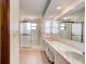 Double vanity bathroom with a large mirror and a walk-in shower at 824 Eel Ave, New Smyrna Beach, FL 32169