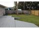 Fenced backyard with deck and storage shed at 1033 Deer Springs Rd, Port Orange, FL 32129